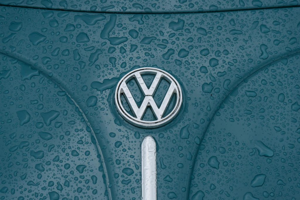 Volkswagen emblem on a rain-covered vehicle