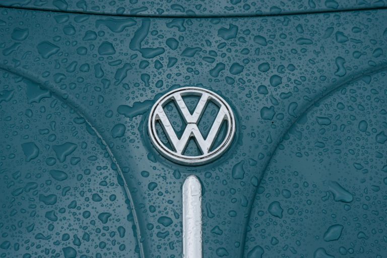 Volkswagen emblem on a rain-covered vehicle